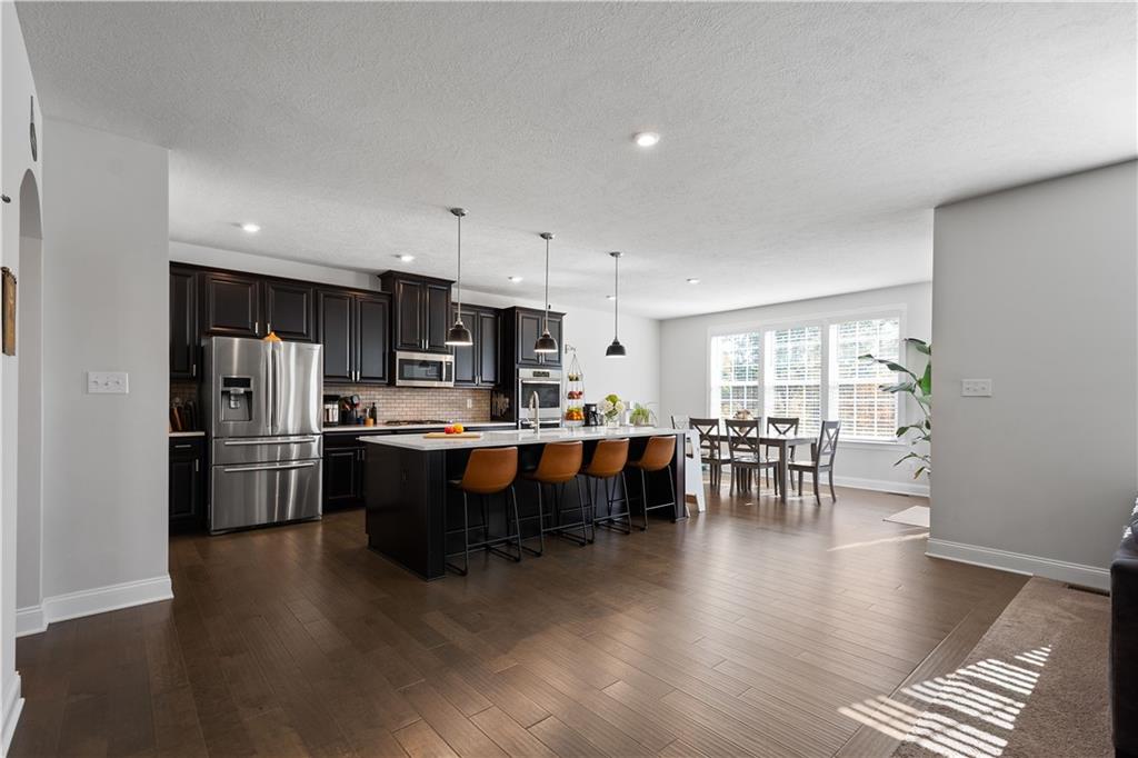 217 Sonni Lane McKees Rocks, PA 15136 - Photo 13 of 34 a kitchen with stainless steel appliances a dining table chairs and a refrigerator