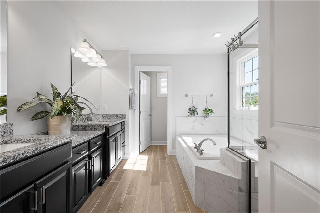 217 Sonni Lane McKees Rocks, PA 15136 - Photo 27 of 34 a spacious bathroom with a granite countertop sink a mirror and a bathtub