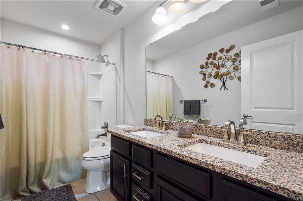 217 Sonni Lane McKees Rocks, PA 15136 - Photo 31 of 34 a bathroom with a granite countertop sink a toilet and a mirror
