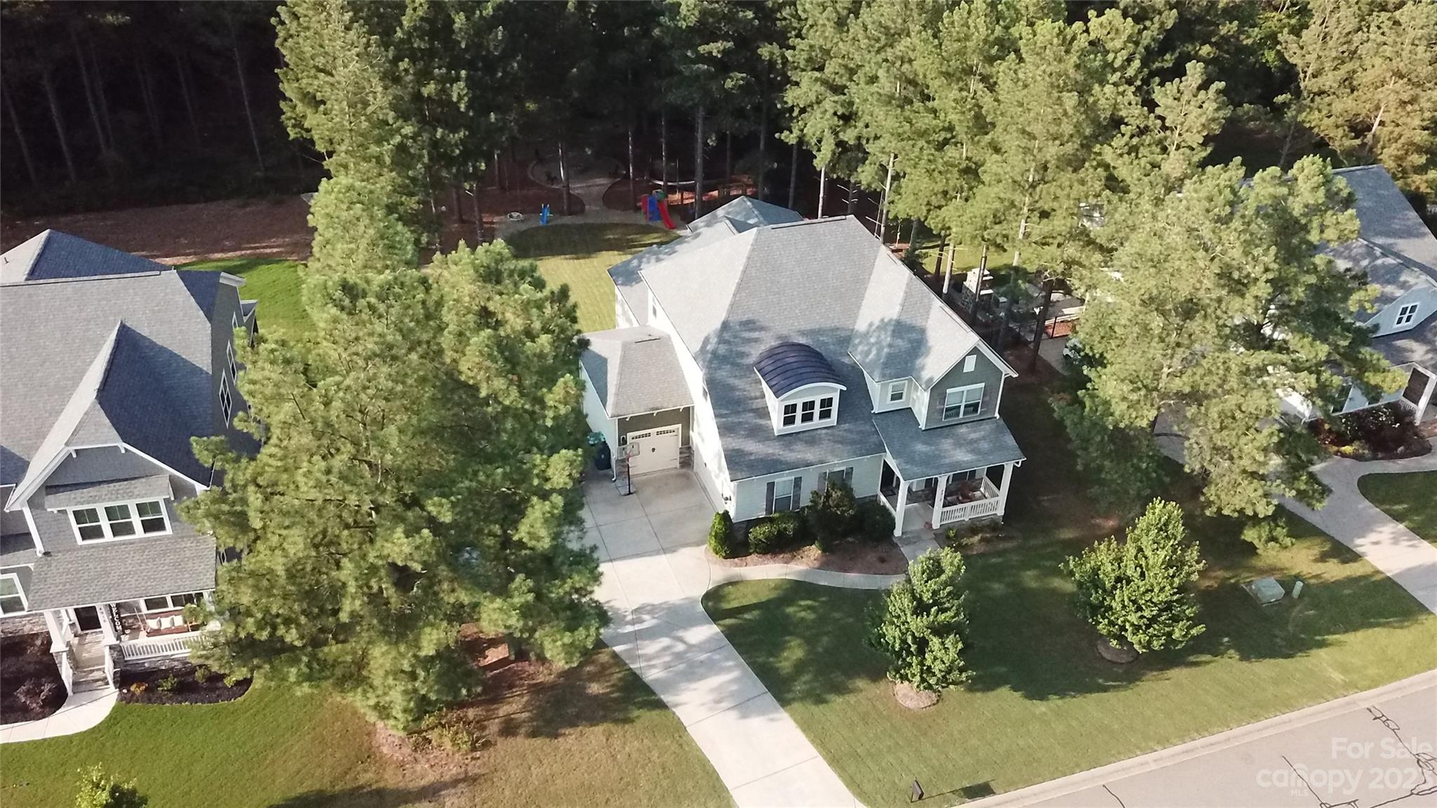 an aerial view of a house with yard swimming pool and outdoor seating