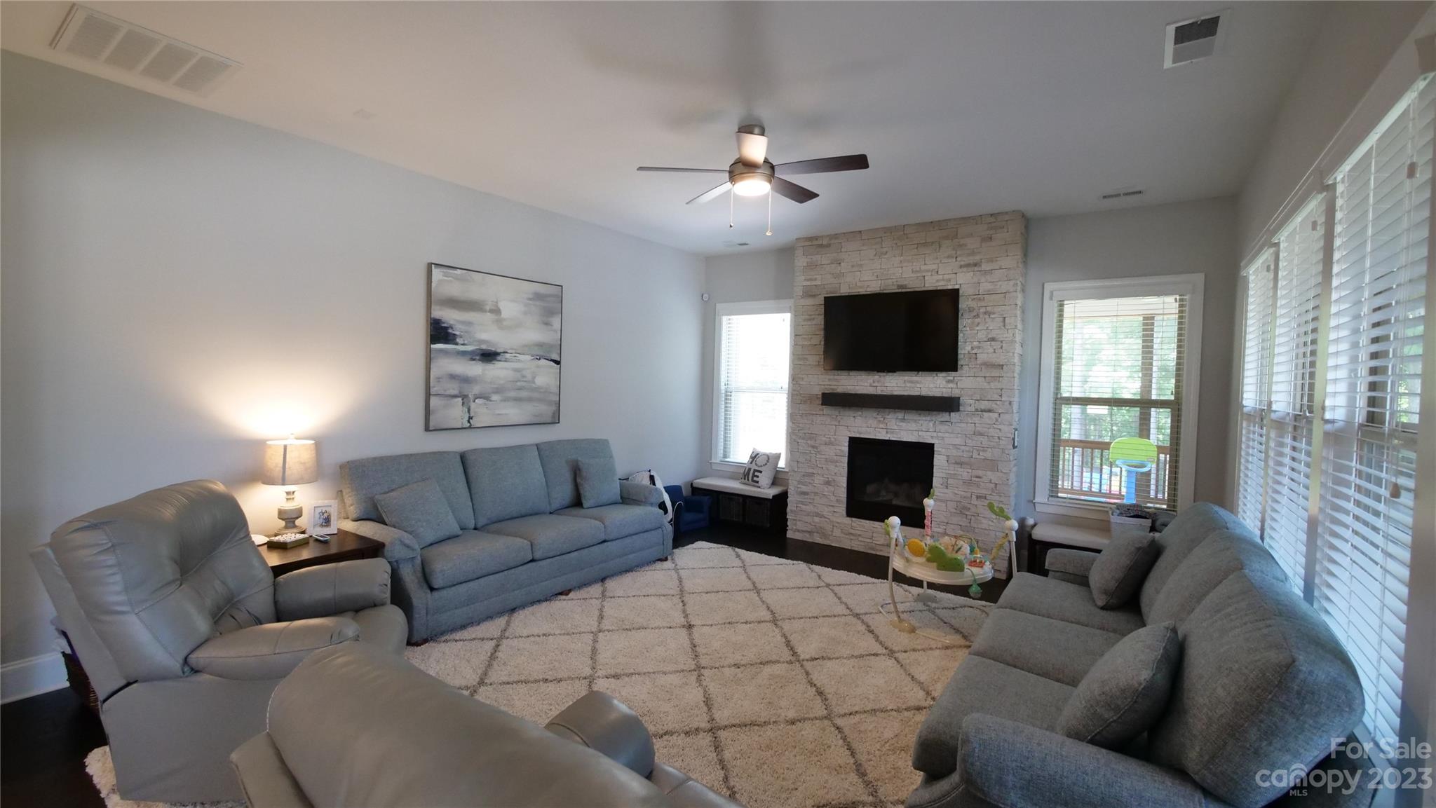 4912 Killian Crossing Drive Denver, NC 28037 - Photo 12 of 38 a living room with furniture a fireplace and a flat screen tv