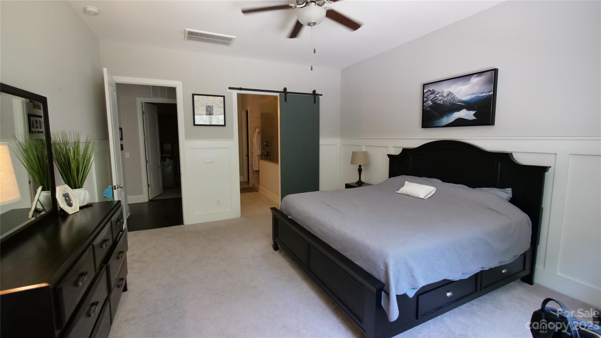 4912 Killian Crossing Drive Denver, NC 28037 - Photo 13 of 38 a bedroom with a bed and a flat tv screen on dresser