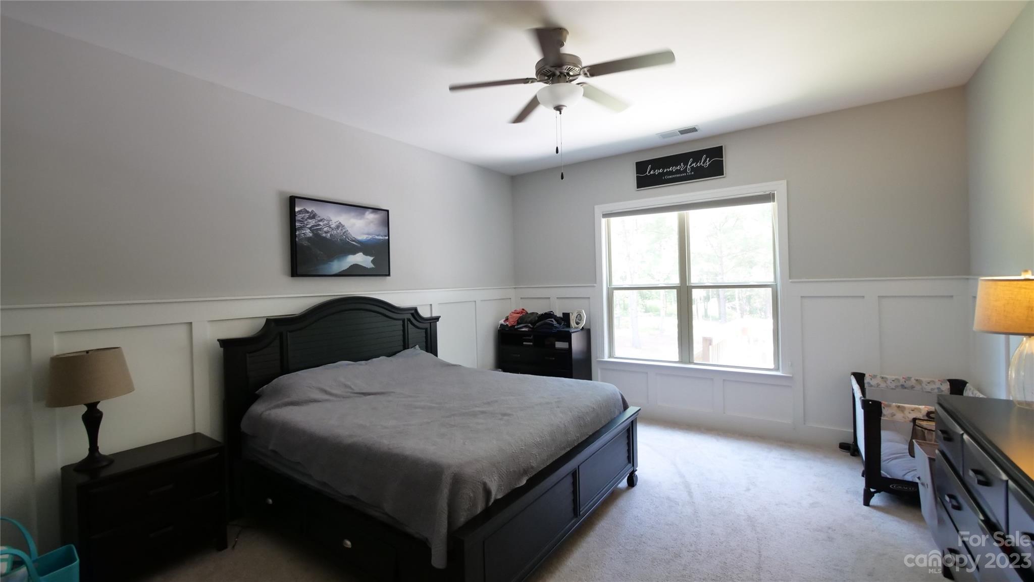 4912 Killian Crossing Drive Denver, NC 28037 - Photo 14 of 38 a bedroom with a bed a chandelier and a window
