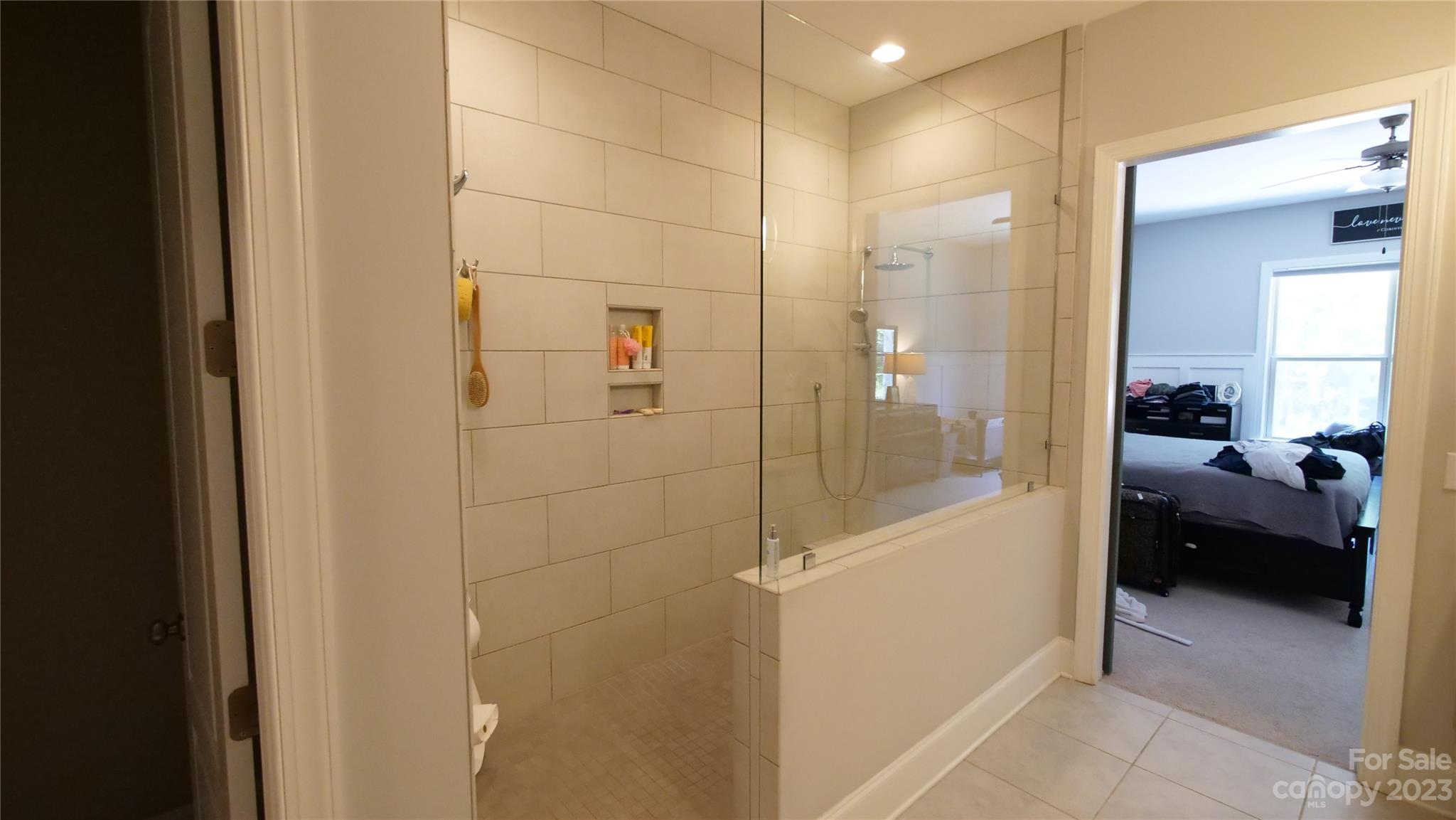 4912 Killian Crossing Drive Denver, NC 28037 - Photo 16 of 38 a bathroom with a glass shower door and a bathroom