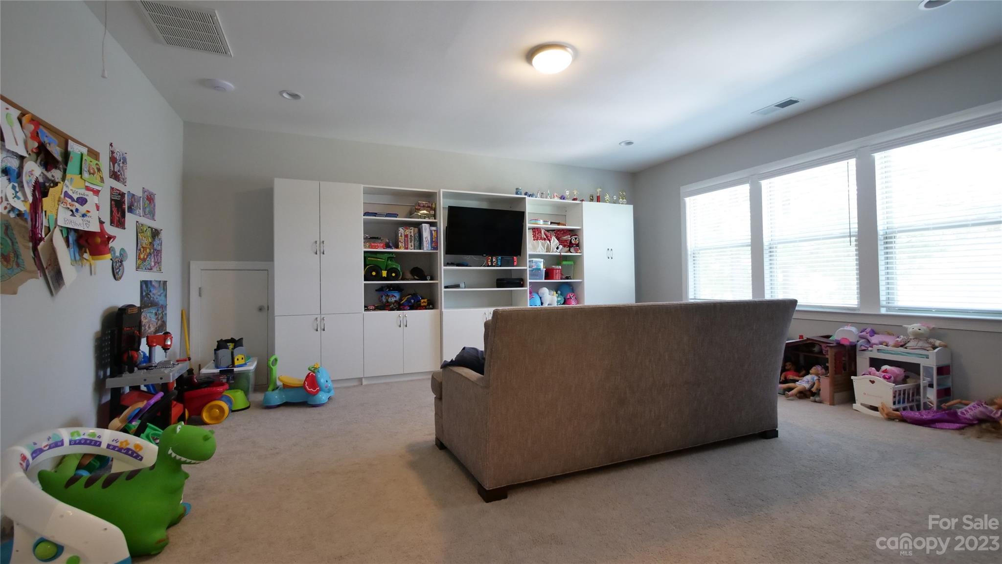 4912 Killian Crossing Drive Denver, NC 28037 - Photo 21 of 38 a living room with furniture and a flat screen tv