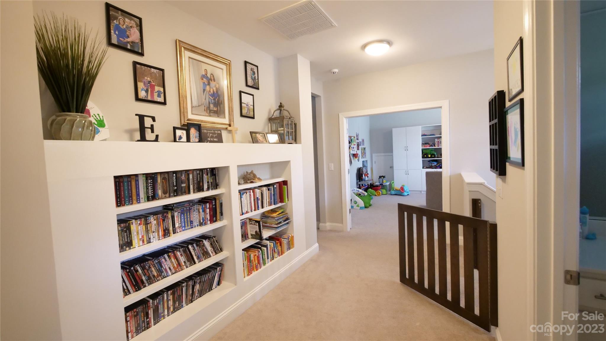 4912 Killian Crossing Drive Denver, NC 28037 - Photo 23 of 38 a living room with furniture and a book shelf