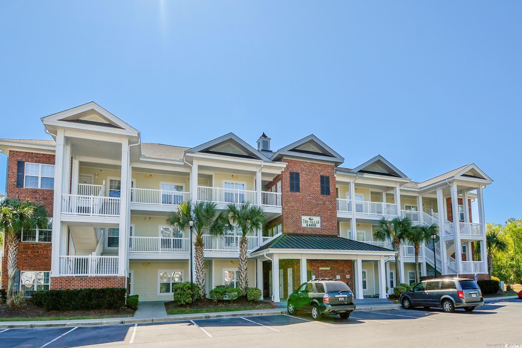 1029 Ray Costin Way, Unit VILLA 906 Murrells Inlet, SC 29576 - Photo 1 of 40 View of building exterior featuring uncovered parking
