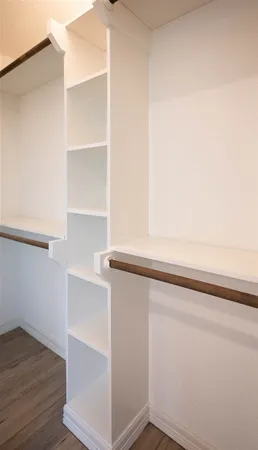 a view of storage and utility room with wooden floor