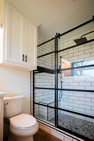 a bathroom with a sink toilet vanity and mirror