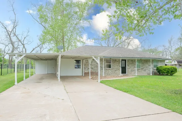 front view of a house with a yard and potted plants
