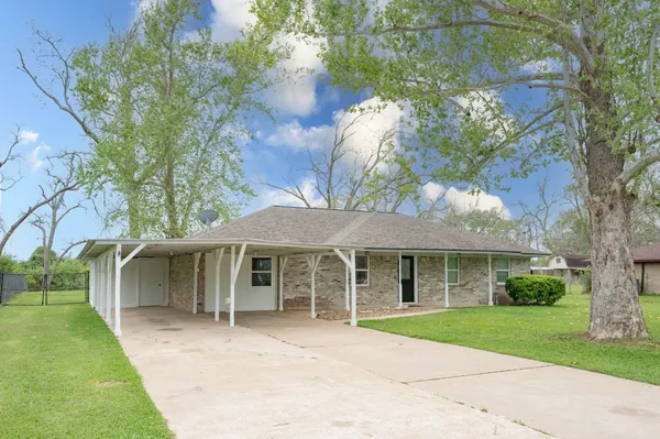 a front view of a house with a garden and yard