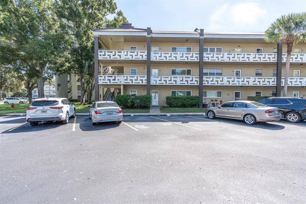 2417 Persian Drive, Unit 23 Clearwater, FL 33763 - Photo 2 of 48 a building with cars parked in front of it