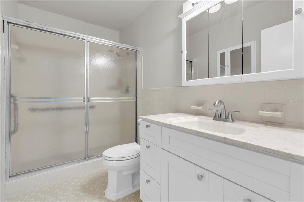 2417 Persian Drive, Unit 23 Clearwater, FL 33763 - Photo 21 of 48 a bathroom with a granite countertop sink toilet and shower