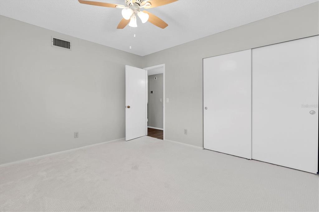 2417 Persian Drive, Unit 23 Clearwater, FL 33763 - Photo 25 of 48 an empty room with a chandelier fan