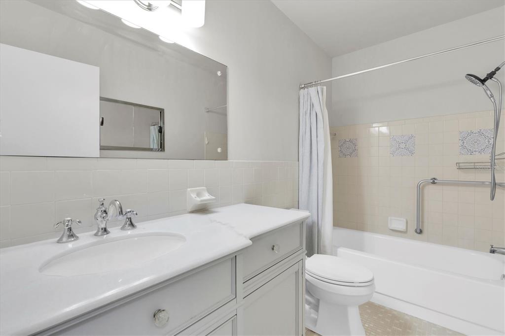 2417 Persian Drive, Unit 23 Clearwater, FL 33763 - Photo 27 of 48 a bathroom with a sink a toilet and shower