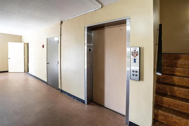 a view of a hallway with wooden floor and entryway