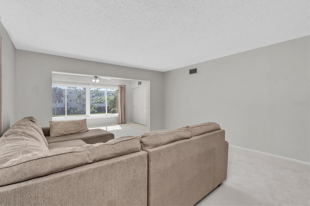 2417 Persian Drive, Unit 23 Clearwater, FL 33763 - Photo 5 of 48 a living room with furniture and a window