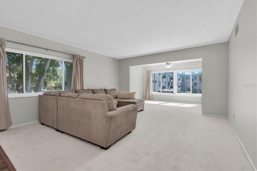 2417 Persian Drive, Unit 23 Clearwater, FL 33763 - Photo 6 of 48 a living room with furniture and a large window