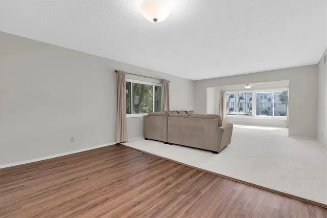 a living room with hard wood floors and a window