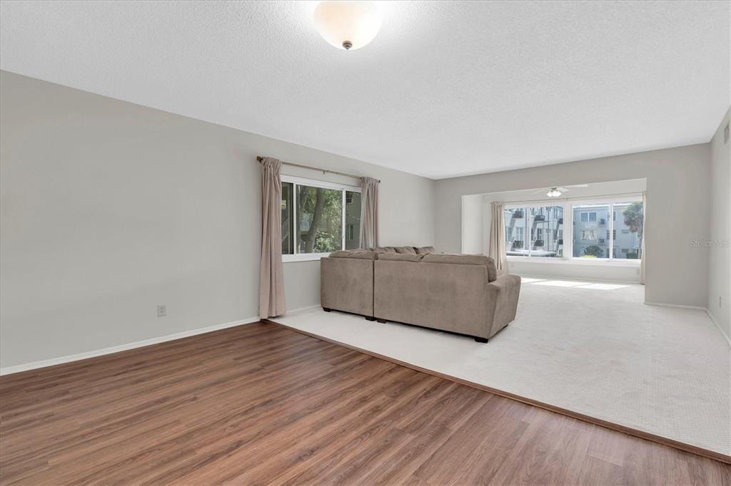 2417 Persian Drive, Unit 23 Clearwater, FL 33763 - Photo 9 of 48 a living room with hard wood floors and a window