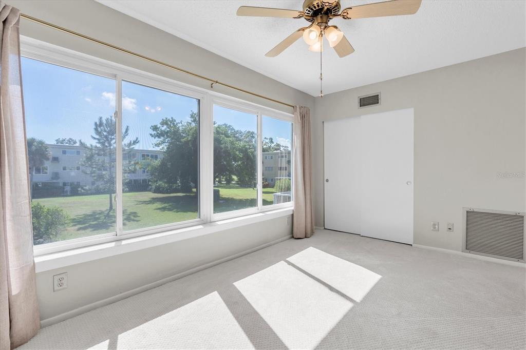 2417 Persian Drive, Unit 23 Clearwater, FL 33763 - Photo 10 of 48 a view of room with window and a ceiling fan