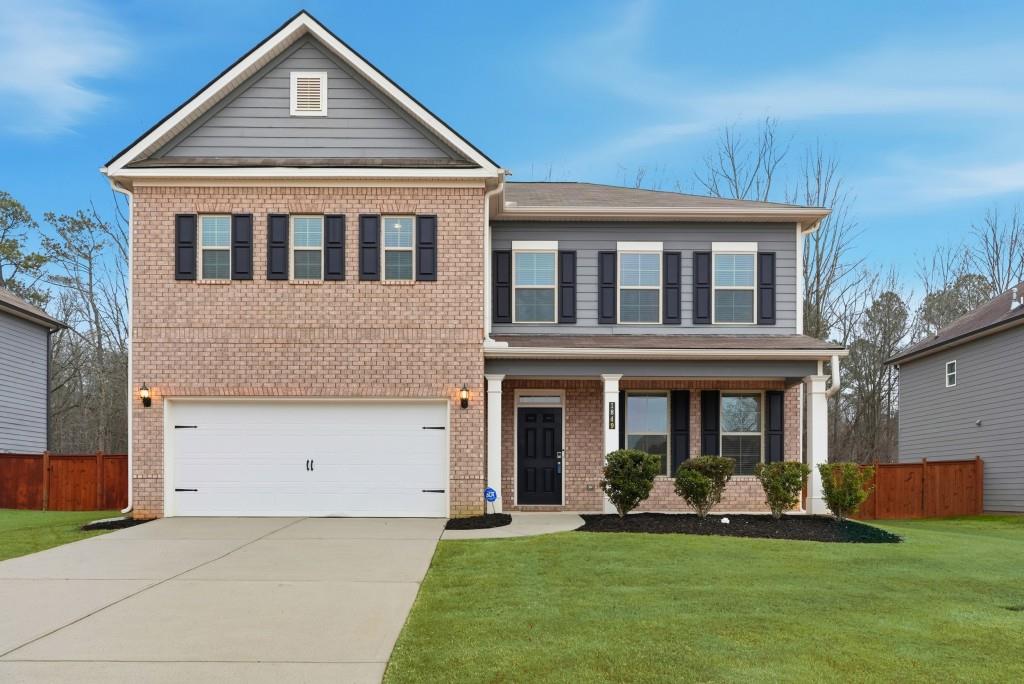 a front view of a house with a yard and porch