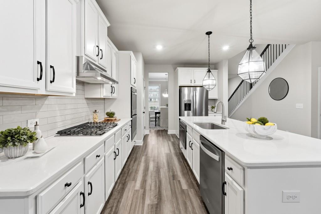 1849 Hanwoo Lane Powder Springs, GA 30127 - Photo 13 of 47 a kitchen with a sink a counter space and stainless steel appliances