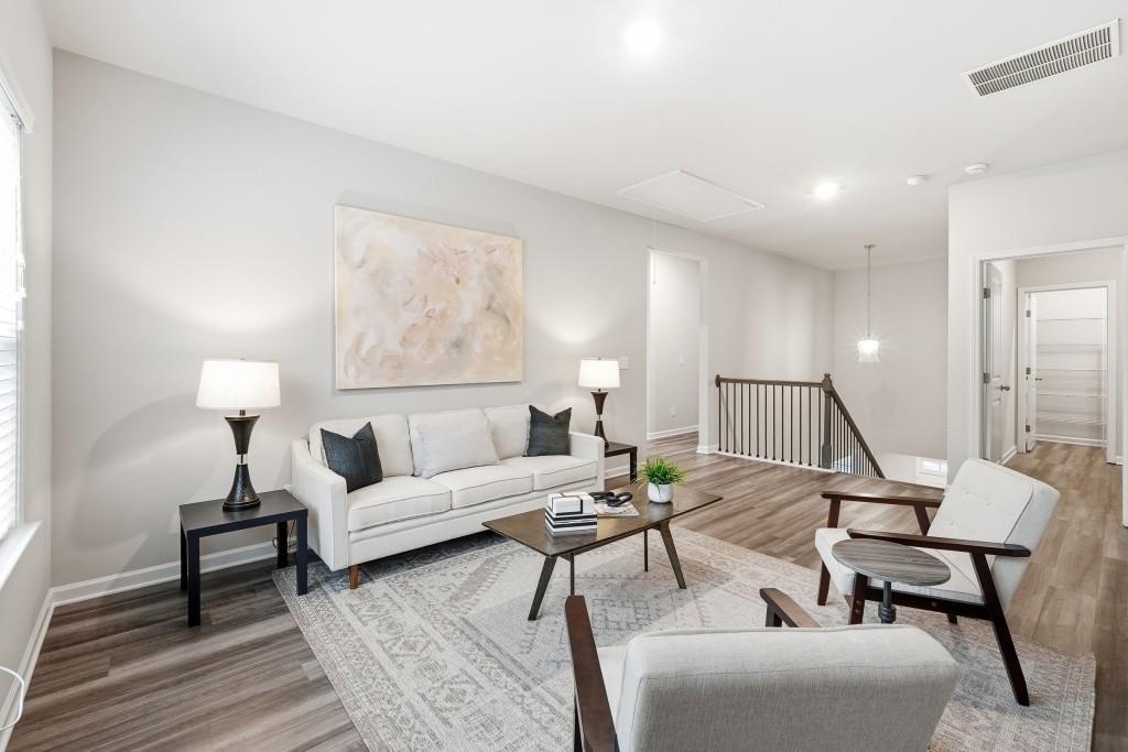1849 Hanwoo Lane Powder Springs, GA 30127 - Photo 21 of 47 a living room with furniture and a lamp