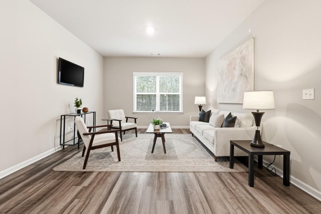 1849 Hanwoo Lane Powder Springs, GA 30127 - Photo 22 of 47 a living room with furniture and a wooden floor