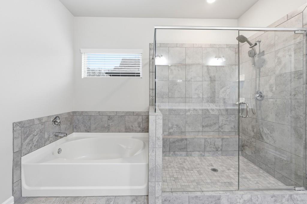 1849 Hanwoo Lane Powder Springs, GA 30127 - Photo 26 of 47 a bathroom with a bathtub and a shower