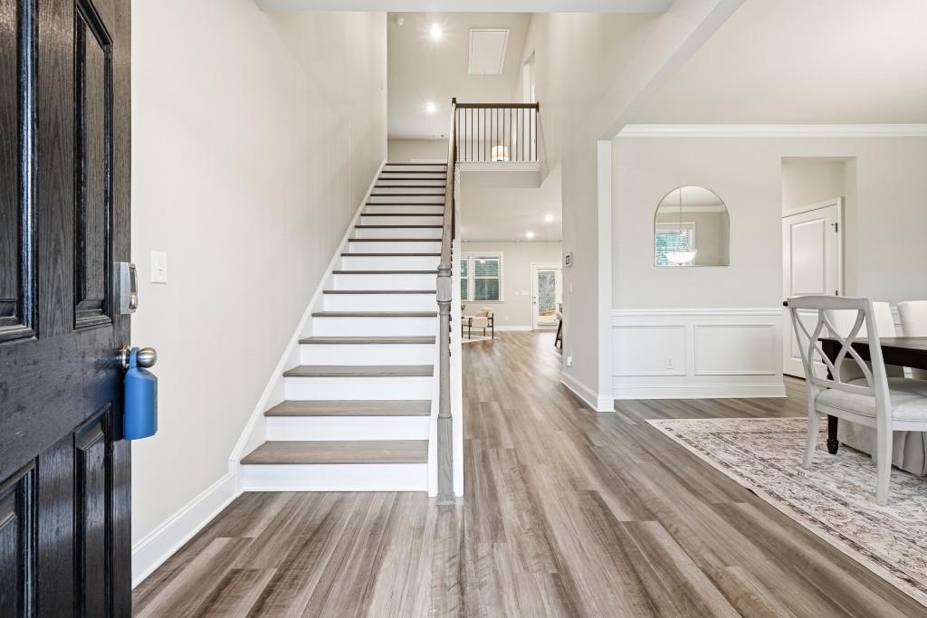 1849 Hanwoo Lane Powder Springs, GA 30127 - Photo 6 of 47 a view of a hallway with wooden floor and staircase