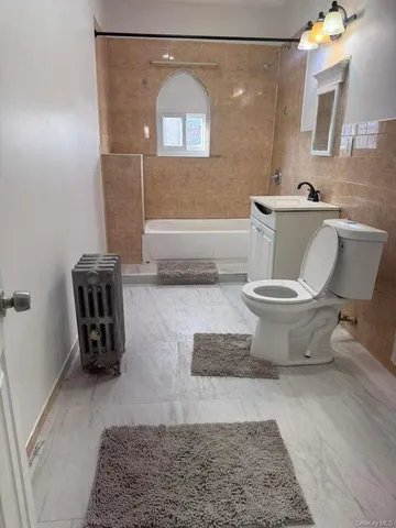 a bathroom with a toilet and a mirror