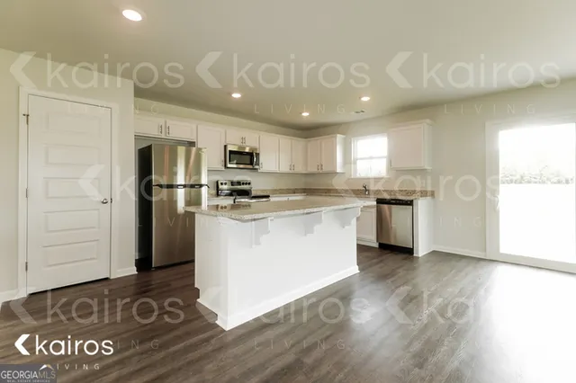 a kitchen with a refrigerator a stove top oven a sink and dishwasher