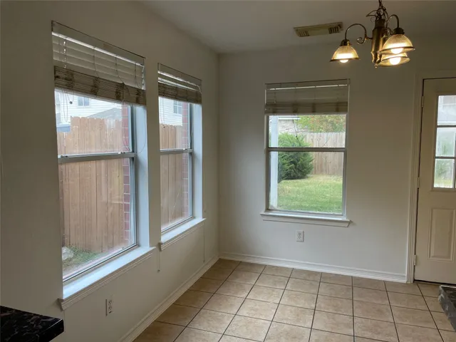 a kitchen with granite countertop a refrigerator and a stove top oven