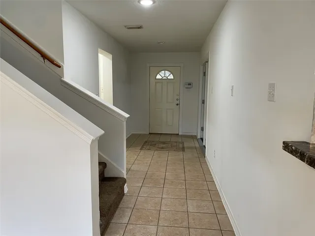 a bathroom with a granite countertop sink and a bathtub