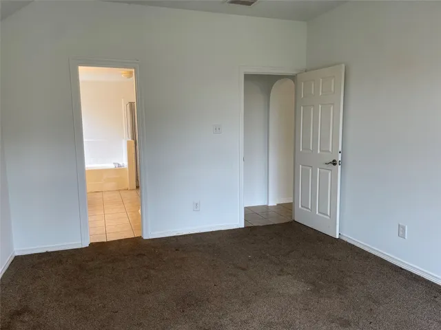 a backyard of a house with plants and brick wall