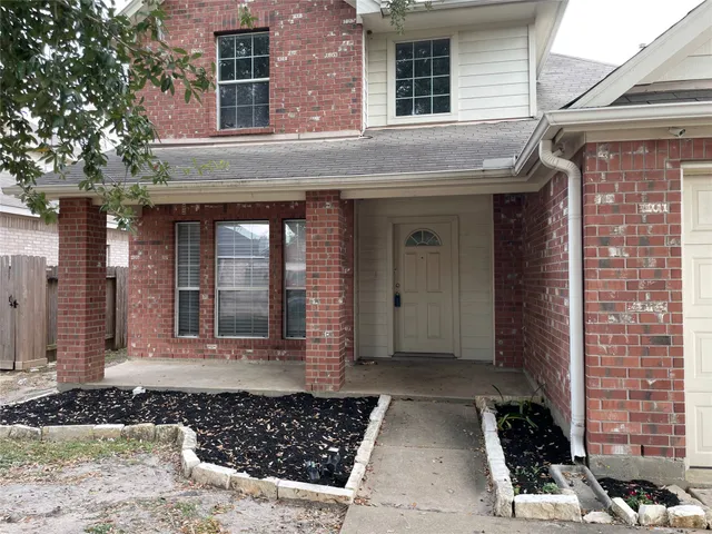 a view of a brick house with a large windows