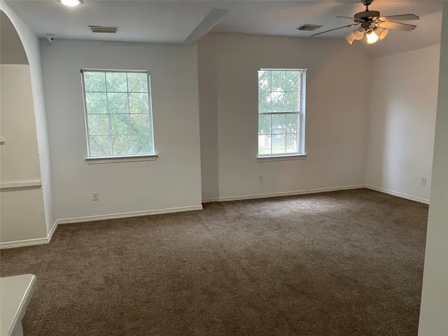 an empty room with window and mirror