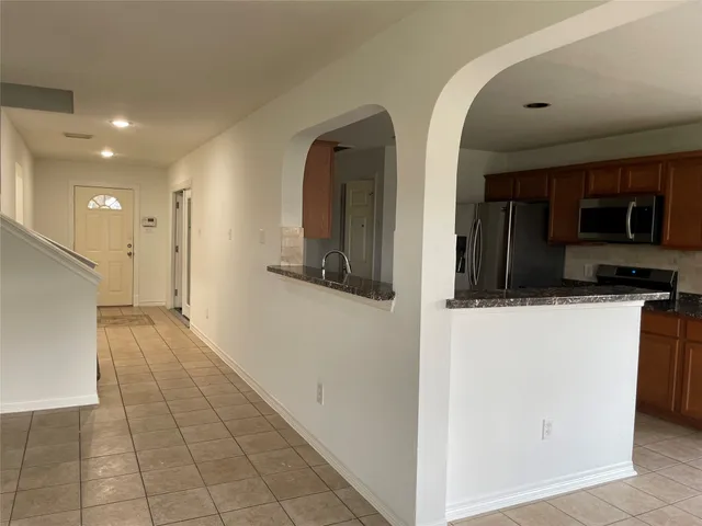 a view of a kitchen from the hallway