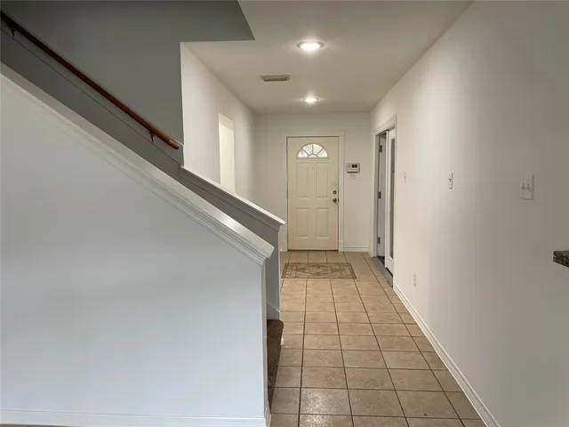 an empty room with window and door