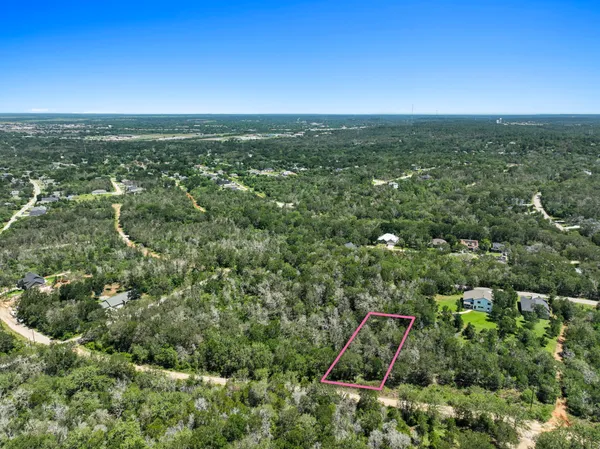 an aerial view of residential houses with city view