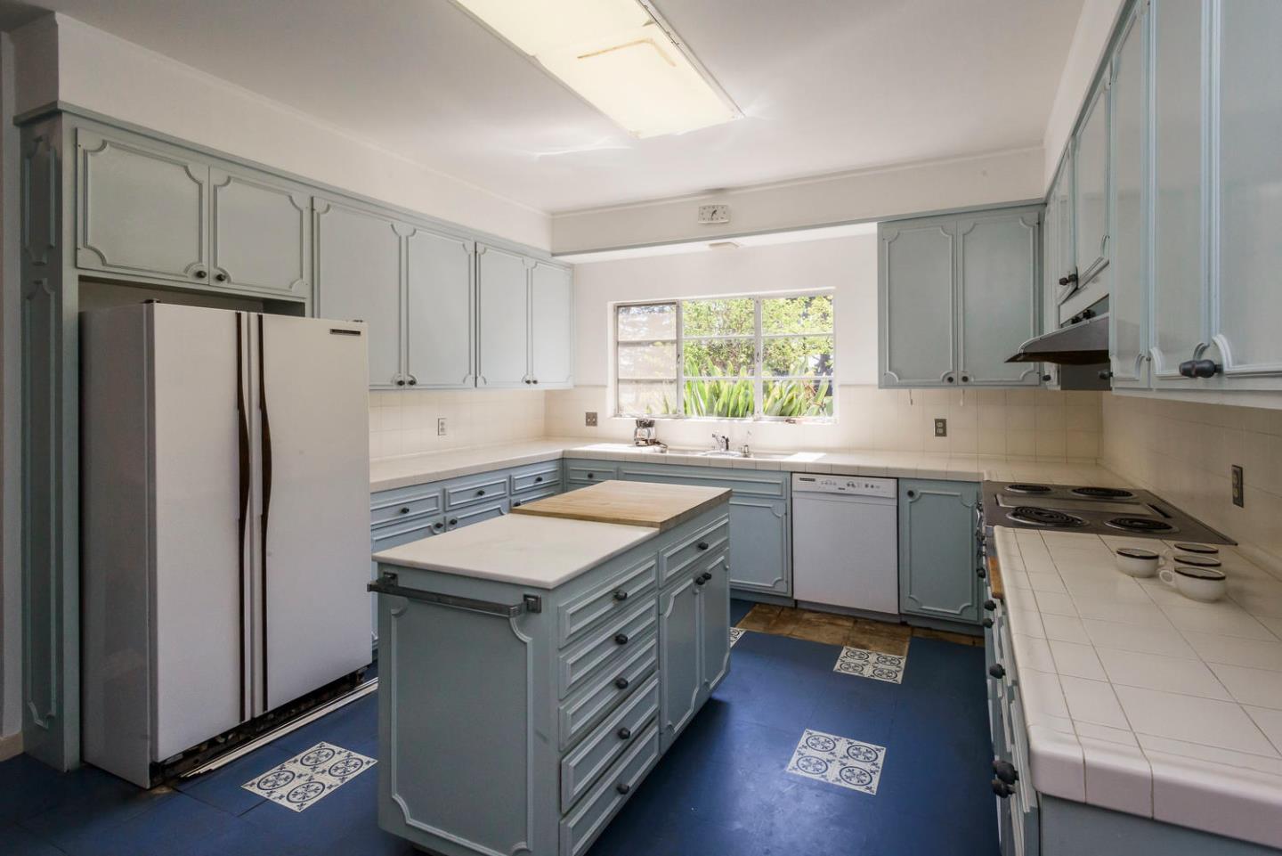 460 Pullman Road Hillsborough, CA 94010 - Photo 12 of 34 a kitchen with a sink stove and refrigerator