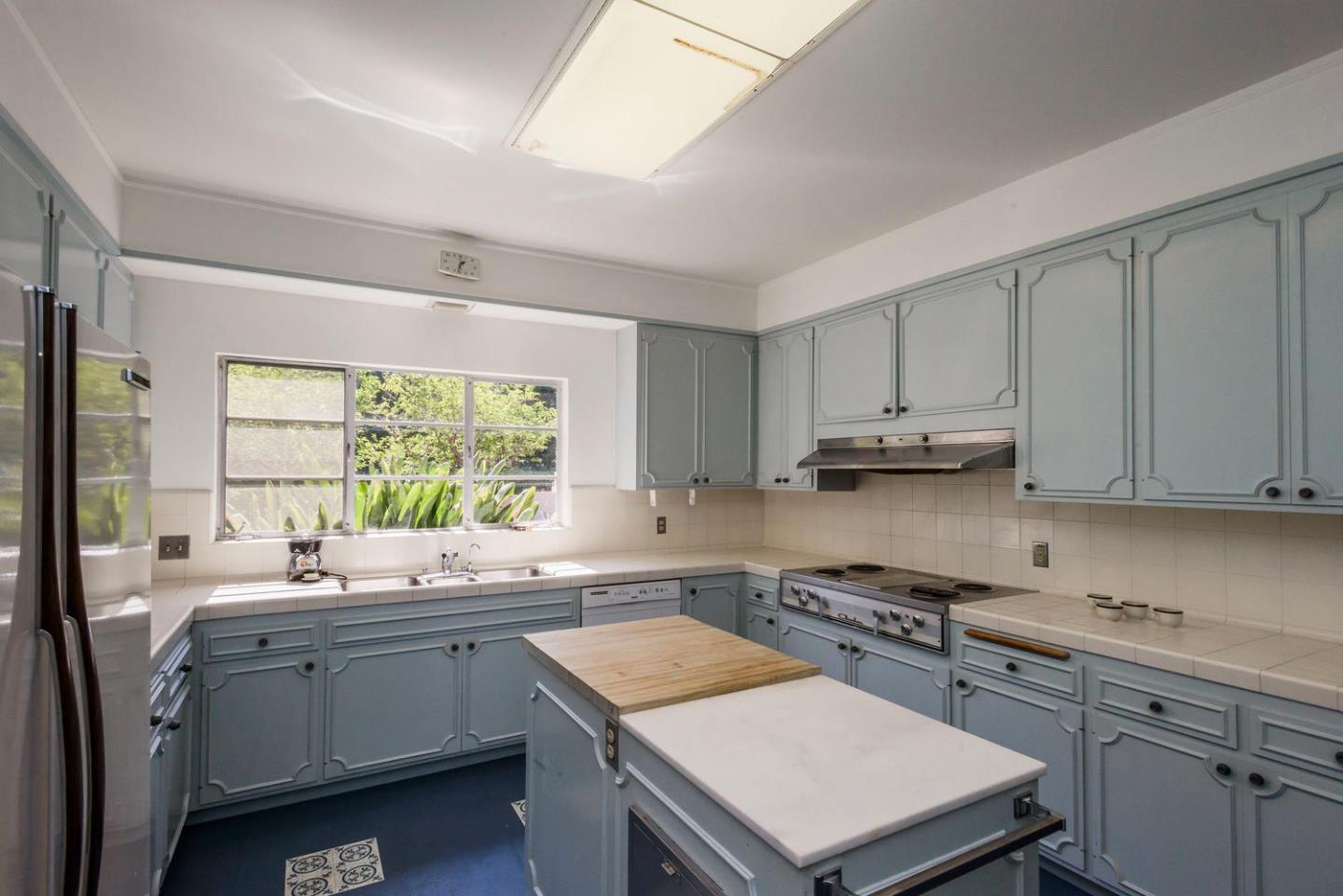 460 Pullman Road Hillsborough, CA 94010 - Photo 13 of 34 a kitchen with a sink stove top oven and cabinets