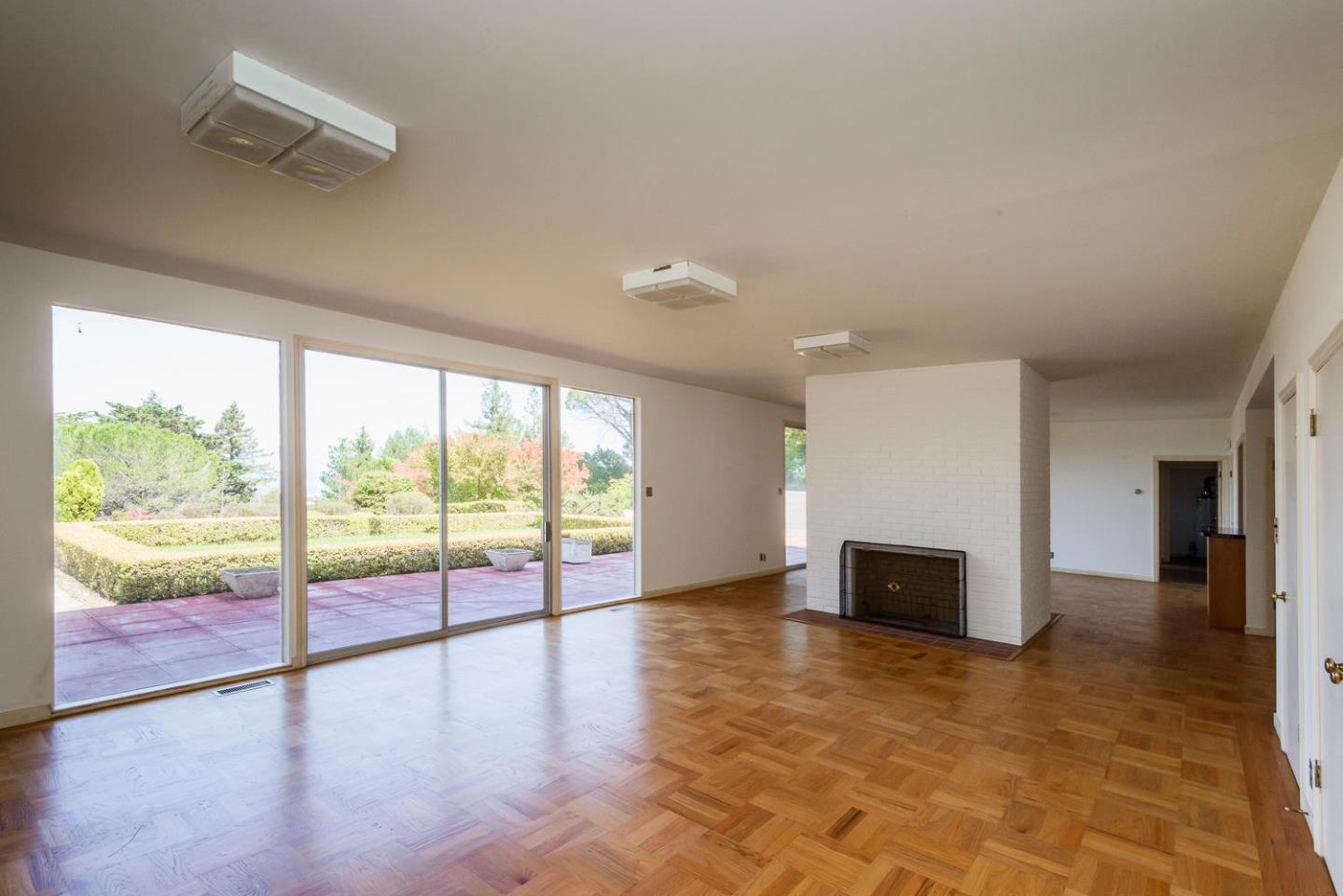 460 Pullman Road Hillsborough, CA 94010 - Photo 17 of 34 a view of empty room with wooden floor and fireplace