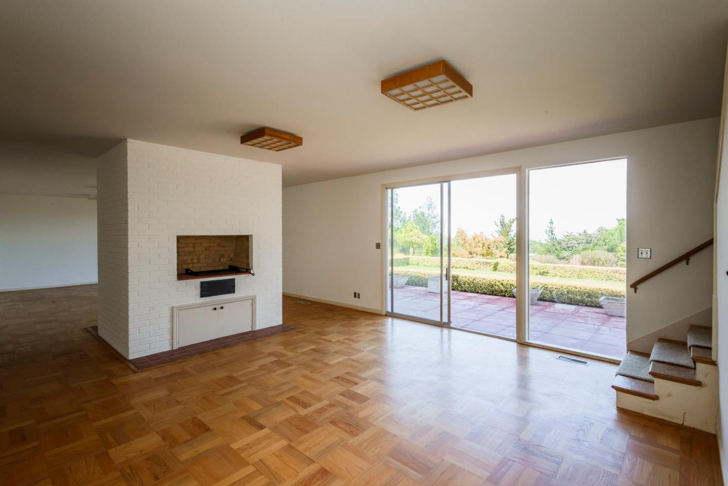 460 Pullman Road Hillsborough, CA 94010 - Photo 18 of 34 a view of a livingroom with furniture flat screen tv and floor to ceiling window