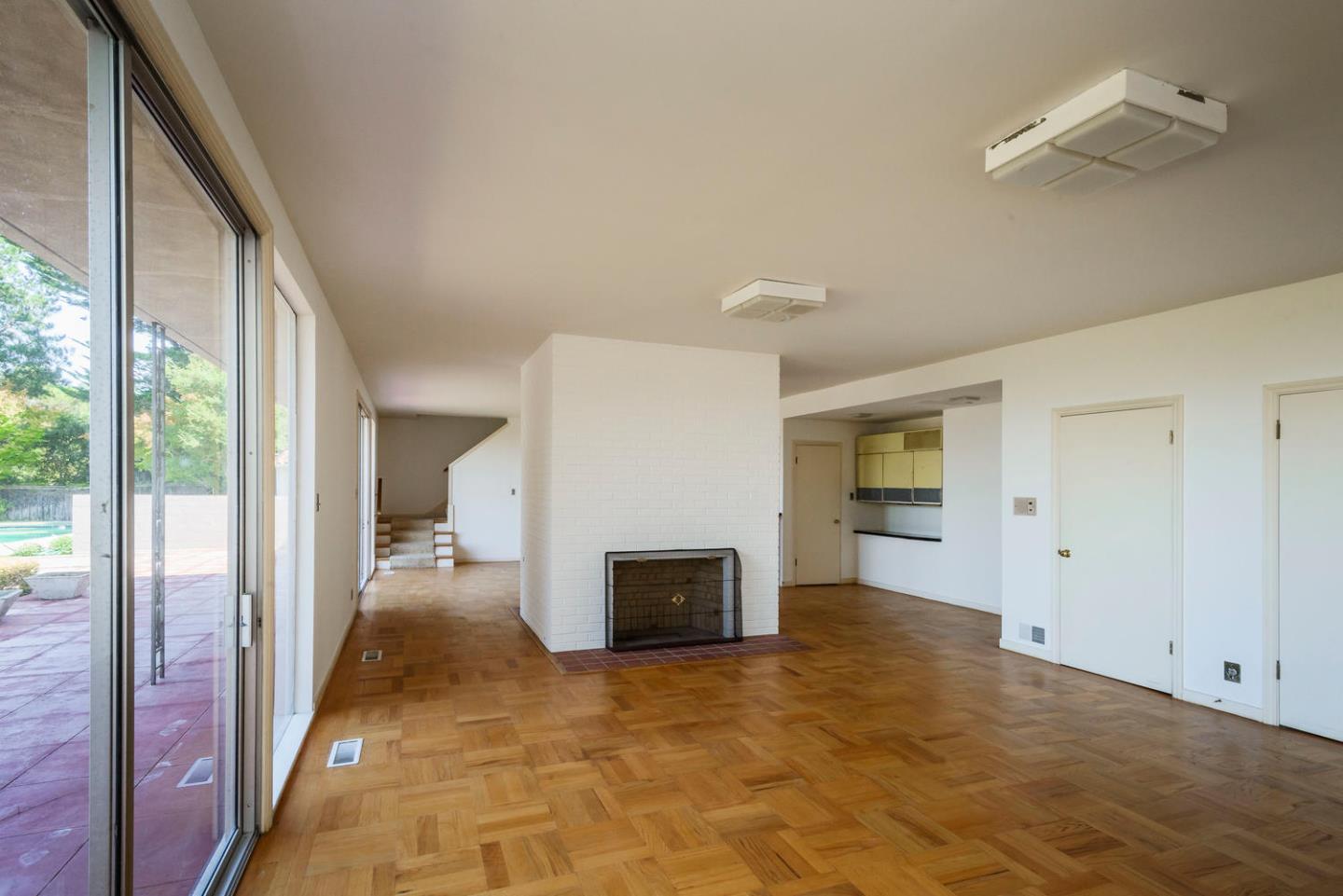 460 Pullman Road Hillsborough, CA 94010 - Photo 19 of 34 a view of a big room with windows and fireplace