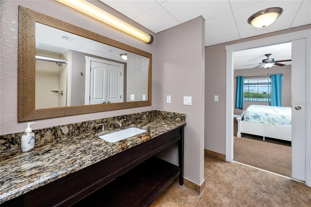 399 2nd Street, Unit 217 Indian Rocks Beach, FL 33785 - Photo 18 of 44 a en suite bathroom with a sink and a mirror