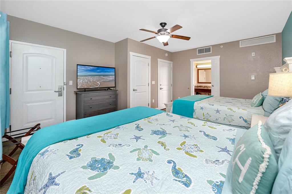 399 2nd Street, Unit 217 Indian Rocks Beach, FL 33785 - Photo 22 of 44 a bedroom with a bed and a chandelier