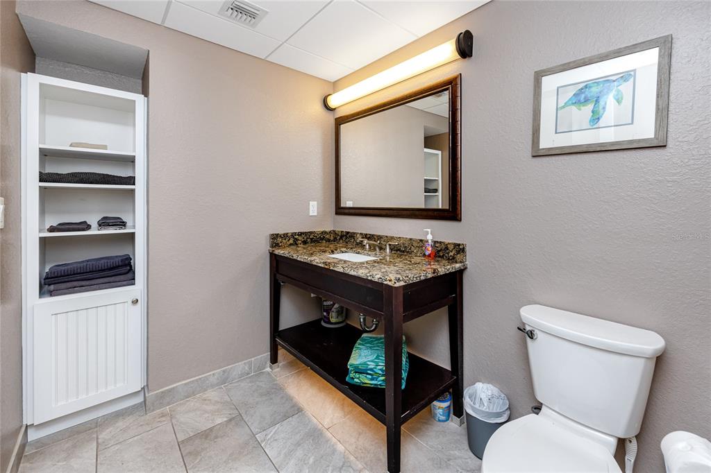 399 2nd Street, Unit 217 Indian Rocks Beach, FL 33785 - Photo 23 of 44 a bathroom with a toilet a sink and a mirror