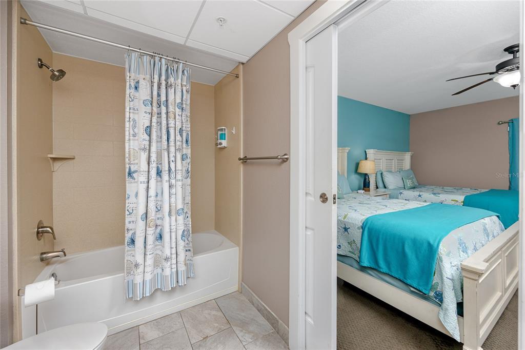 399 2nd Street, Unit 217 Indian Rocks Beach, FL 33785 - Photo 24 of 44 a bathroom with a tub and a shower